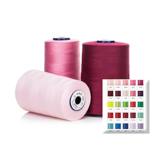 May include: Three spools of thread in shades of pink and burgundy, with a colour chart showing various thread colours. The spools are cylindrical, with one lying on its side. The thread is labelled "VIGA 120".