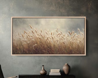 May include: A framed landscape art print featuring a field of tall, golden wheat swaying in the wind under a cloudy sky. The artwork is displayed above a black cabinet with decorative vases and books, creating a serene and natural aesthetic.