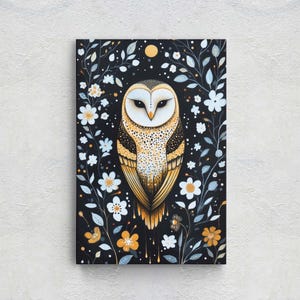 May include: A painting of a white and brown barn owl with yellow eyes. The owl is surrounded by white flowers and dark green leaves on a black background.