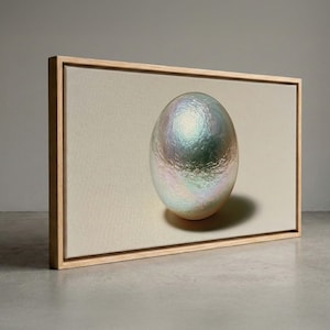 May include: A rectangular canvas print featuring a centered, large, iridescent pearl with a textured, shimmering surface displaying hues of blue, green, and pink, set against a neutral off-white background, enclosed in a light-toned wooden frame.