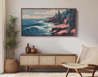 May include: A framed landscape art print depicts a coastal scene with a rocky shoreline, crashing waves, and evergreen trees. The artwork features a color palette of blues, pinks, and greens, with a wooden frame. The print is displayed above a wooden cabinet.