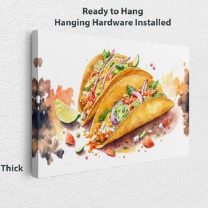 May include: Three watercolor tacos with various fillings, including avocado, onion, and tomato, on a white background with splashes of color. Ready to Hang. Hanging Hardware Installed. 1.25" Thick.