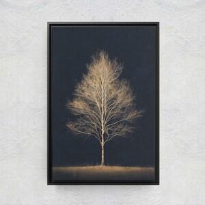 May include: A framed art print featuring a bare tree with golden-colored branches against a dark blue background. The tree is centered, with a hint of a golden ground at the base. The artwork is in a black frame, mounted on a textured white wall.