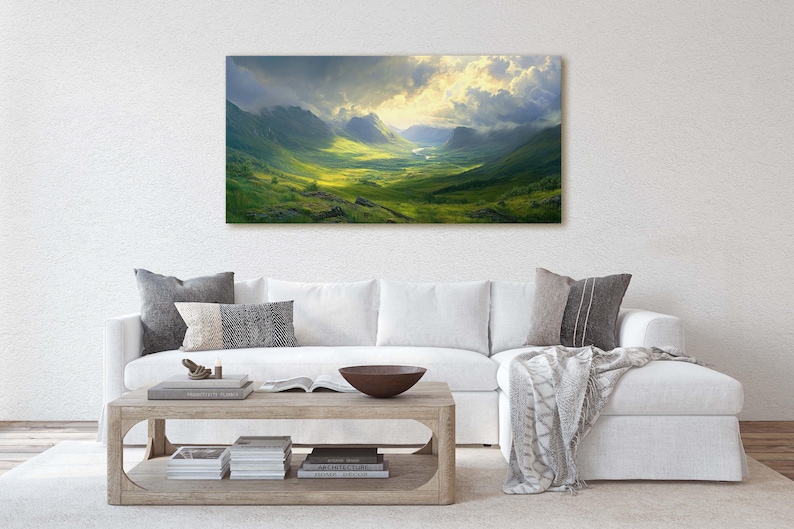 May include: A panoramic landscape photograph of a valley with green hills and mountains under a cloudy sky. The sun is shining through the clouds, creating a bright light in the center of the image.