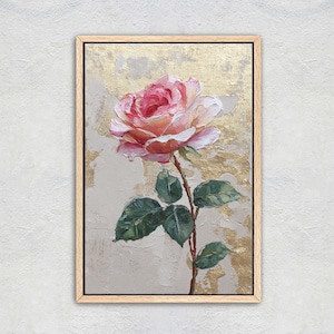 May include: A framed floral painting featuring a large pink rose with green leaves and a brown stem. The background has a gold and beige textured effect. The artwork is displayed in a light brown wooden frame.