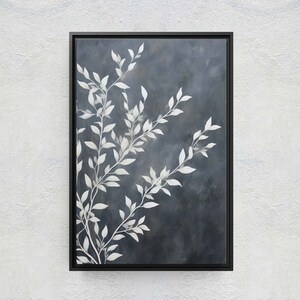 May include: A framed abstract painting with a dark blue background and white stylized branches with leaves.