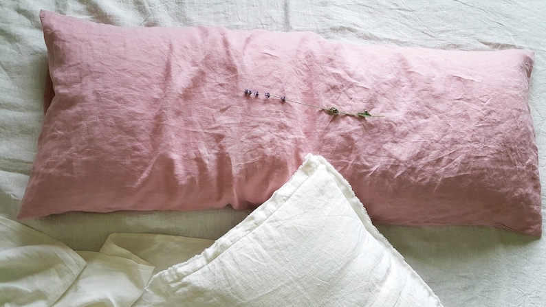 Dusty Rose 100% linen body pillow on the white linen sheet