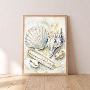 May include: A watercolor painting in a wooden frame featuring a collection of seashells on a sandy background. The artwork displays a large fan-shaped scallop shell, a spiral conch shell, a long razor clam, and two small rounded sea shells.