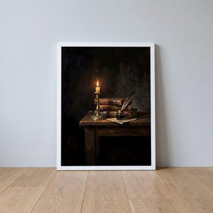 May include: A framed wall art print depicting a dark, moody scene on a wooden table. A lit candle in a brass holder illuminates a stack of three weathered, leather-bound books, a small glass inkwell, and a single quill pen resting on paper.