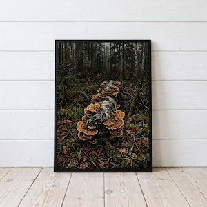 May include: A framed rectangular wall art print depicting a forest scene with a fallen log covered in clusters of orange and brown shelf mushrooms. The dark, moody woodland background features dense trees, mossy ground, and scattered fallen leaves.