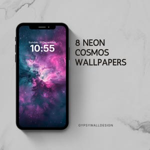 May include: A black smartphone displays a vibrant neon cosmos wallpaper in shades of pink, purple, and teal. The screen shows the date and time: Sunday, December 21, 10:55. The text "8 NEON COSMOS WALLPAPERS" is displayed next to the phone. The design is by GYPSYWALLDESIGN.