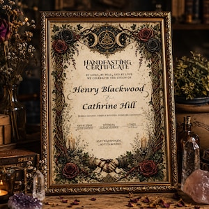 May include: A framed handfasting certificate with ornate floral borders, featuring the names Henry Blackwood and Cathrine Hill. The text includes By cord, by will, and by love we celebrate the union of, Freely bound, deeply rooted, forever choosing, and As it was spoken, so it is bound.