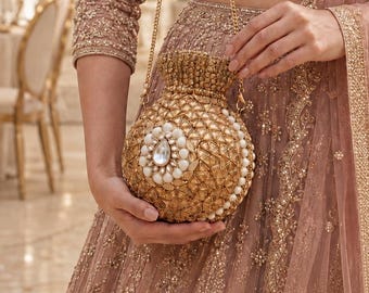 Gold Embellished Bridal Clutch: Round Potli Design with White Stones and Detachable Chain Strap