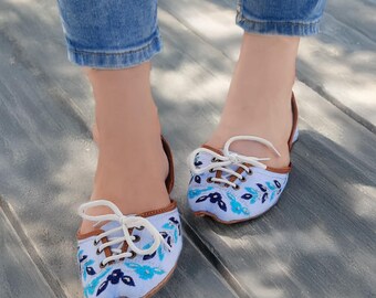 Zapatos planos casuales con cordones en azul claro y bordado floral.