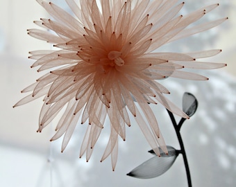 Delicate translucent flower made of nylon mesh and rubber,