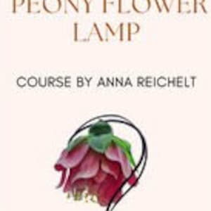 May include: A black metal table lamp with a pink and green peony flower shade. The lamp is turned on and the light is shining through the flower petals.