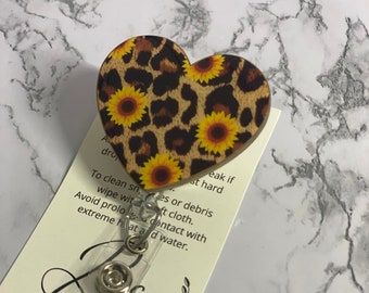 Carrete de insignias con forma de corazón de girasol