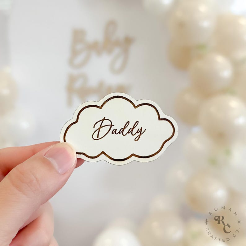 May include: White cloud-shaped wooden sign with a gold outline and the word "Daddy" written in gold script.