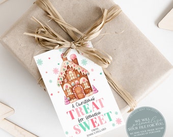 May include: A gift wrapped in brown paper and tied with raffia, featuring a Christmas gift tag. The tag has a watercolor gingerbread house design and the text "A Christmas Treat for someone Sweet."