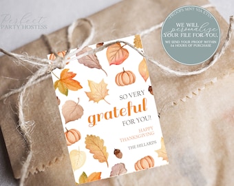 May include: Thanksgiving gift tag featuring watercolour illustrations of autumn leaves and pumpkins. The tag says "So Very Grateful For You!" with "Happy Thanksgiving" and a family name. Tied with twine on a brown paper package.