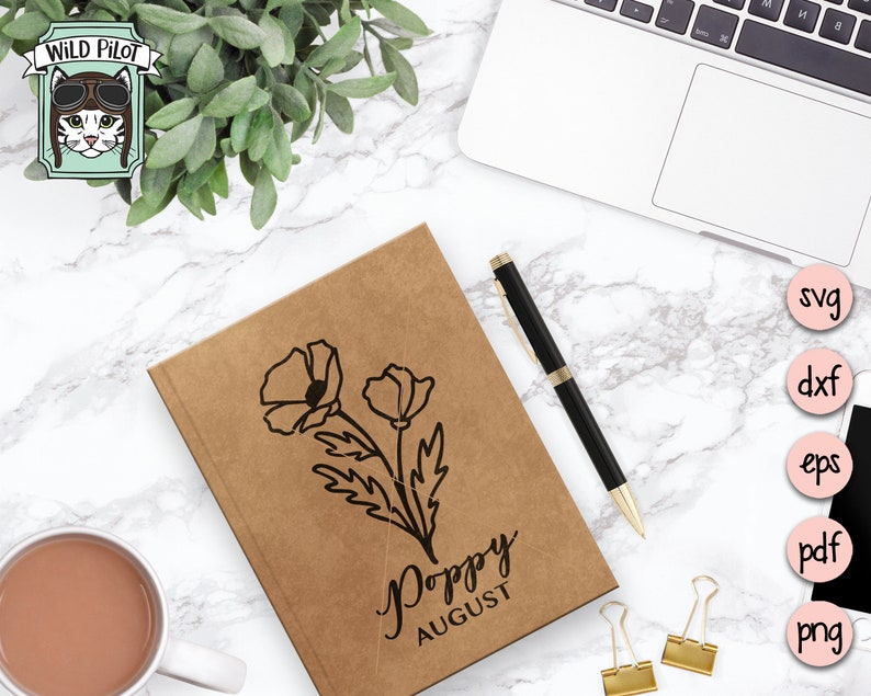 May include: A brown notebook with a black poppy flower illustration and the text "Poppy August".