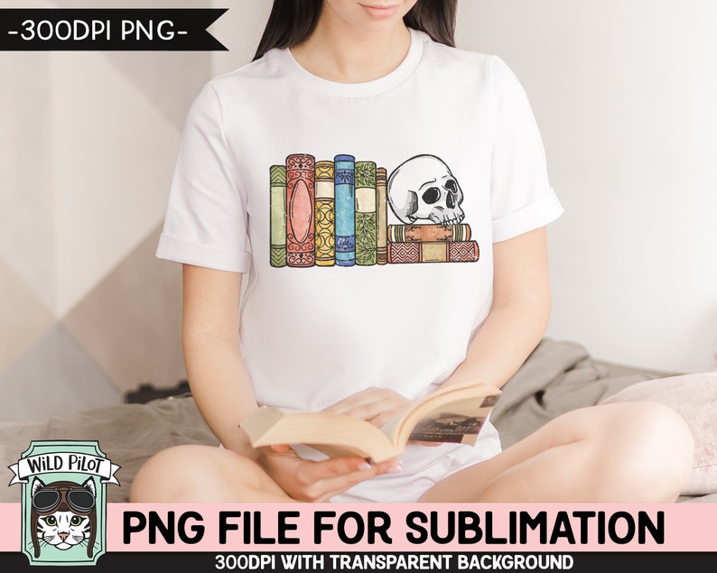 May include: A white t-shirt with a graphic of a skull resting on a stack of colorful books. The graphic is in a vintage style with a distressed look. The t-shirt is being worn by a person sitting on a bed.