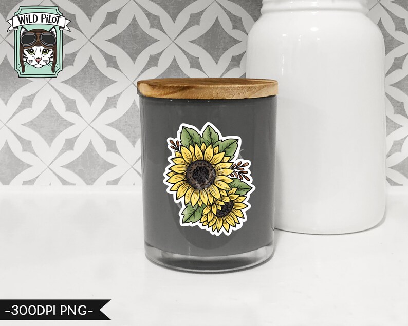 May include: A gray candle jar with a wooden lid and a sunflower decal. The decal features two sunflowers with green leaves and stems.