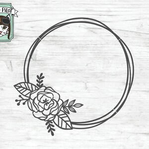 May include: A black and white outline of a circular frame with a floral design on the left side. The frame is double-lined and has a single rose with leaves.