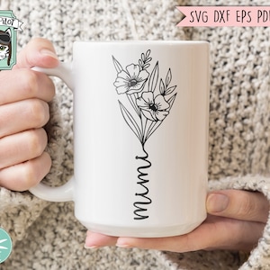 May include: White ceramic mug with a black outline of flowers and the word "mum" in a cursive script.