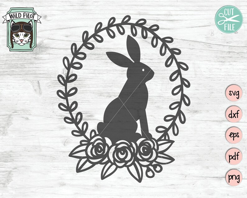 May include: A black silhouette of a rabbit sitting inside a wreath of leaves and flowers. The wreath is made of simple, stylized leaves and three roses.
