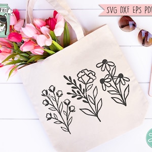 May include: A white tote bag with three black floral designs. The bag is filled with pink and white tulips. The text "WILD PILOT" is visible in the top left corner of the image.