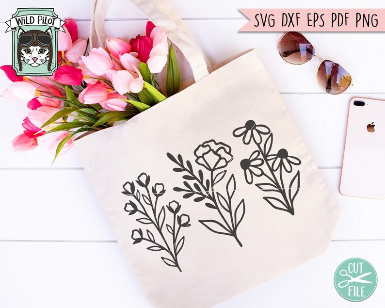 May include: A white tote bag with three black floral designs. The bag is filled with pink and white tulips. The text "WILD PILOT" is visible in the top left corner of the image.