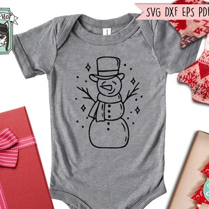 May include: A gray baby onesie with a black line drawing of a snowman wearing a hat and scarf. The snowman is surrounded by small stars.
