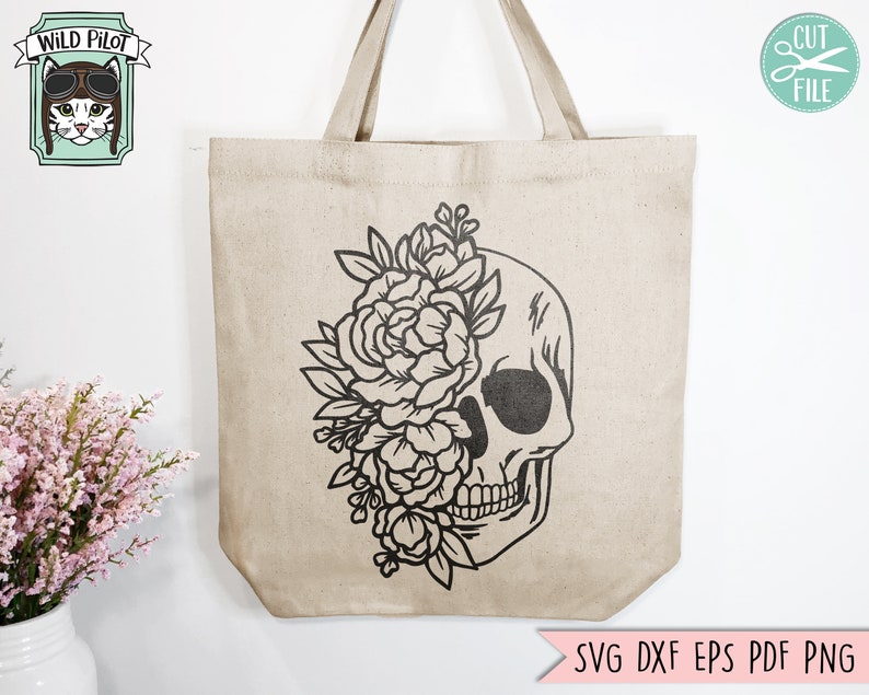 May include: A tote bag with a black and white design of a skull with flowers growing out of the eye socket. The text "SVG DXF EPS PDF PNG" is at the bottom of the bag.