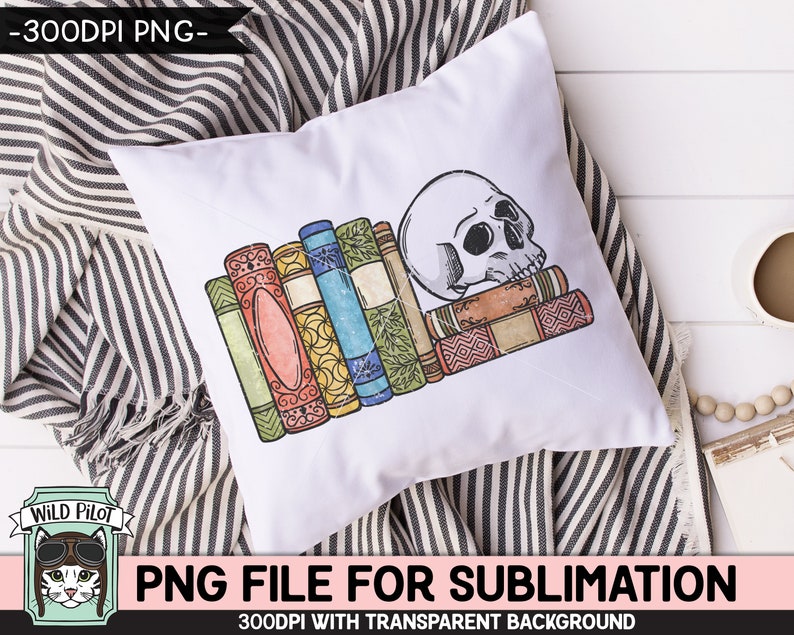 May include: A white pillow with a stack of colorful books and a white skull on top. The books have a vintage look and are stacked on top of each other. The skull is facing to the right and has a detailed design. The pillow is on a striped fabric background.