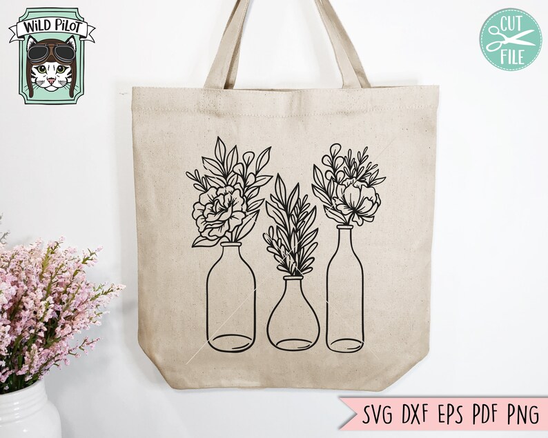 May include: A black and white line drawing of three vases with flowers. The vases are tall and slender, and the flowers are simple and elegant. The design is perfect for a tote bag or other home decor.