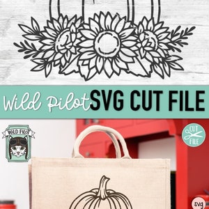 May include: Black and white line art SVG cut file of a pumpkin with sunflowers. The design is shown on a tote bag.