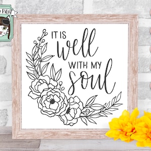 May include: A white sign with a black floral wreath and the text "It is well with my soul".