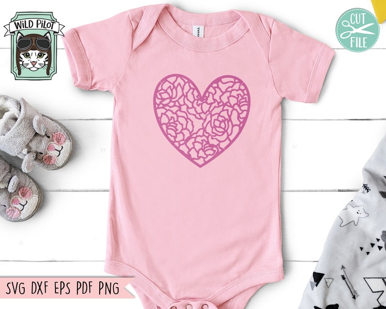 May include: Pink baby onesie with a pink floral heart design.  The onesie has short sleeves and a snap closure.  SVG DXF EPS PDF PNG