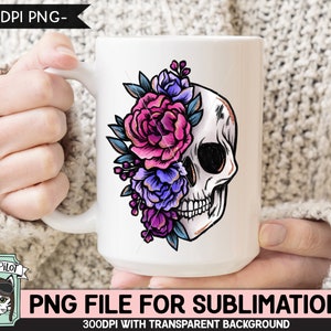Puede incluir: Taza de cer&aacute;mica blanca con un dise&ntilde;o de calavera floral colorido. La calavera est&aacute; parcialmente cubierta por flores rosas, moradas y azules.