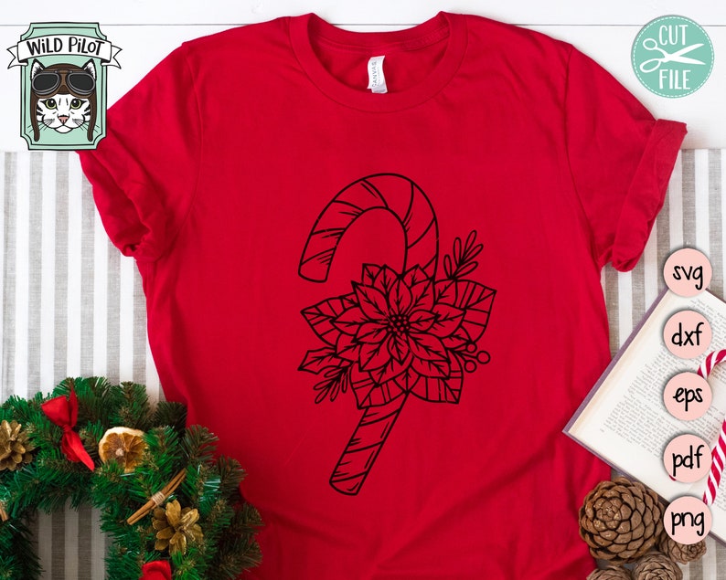 May include: A red t-shirt featuring a black outline of a candy cane and a poinsettia flower.