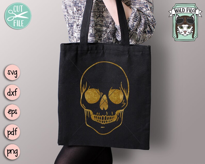 May include: A black tote bag with a gold glitter skull design. The bag has a long handle and is made of canvas.