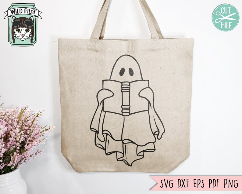 May include: A white tote bag with a black outline of a ghost reading a book. The ghost has two eyes and a mouth. The tote bag has a brown handle.