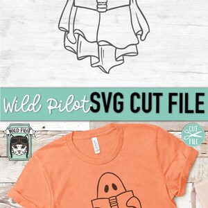 May include: A black and white line art illustration of a ghost reading a book. The ghost is wearing a sheet and has two eyes. The image is on a light orange t-shirt.