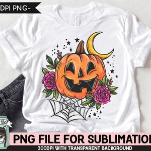 May include: A white t-shirt with a sublimation design of a smiling jack-o'-lantern with a crescent moon, spiderweb, and flowers.  The design is in orange, black, and pink.