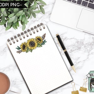 May include: A white notebook with a grid pattern and a spiral binding. The notebook has a drawing of a sunflower bouquet on the front. The bouquet is made up of three sunflowers with brown stems and green leaves. The sunflowers are yellow with brown centers. The notebook is on a white marble surface with a laptop, a pen, and a cup of coffee.