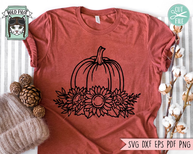 May include: A black and white line drawing of a pumpkin with sunflowers around it. The pumpkin is centered and the sunflowers are arranged around the bottom of the pumpkin.