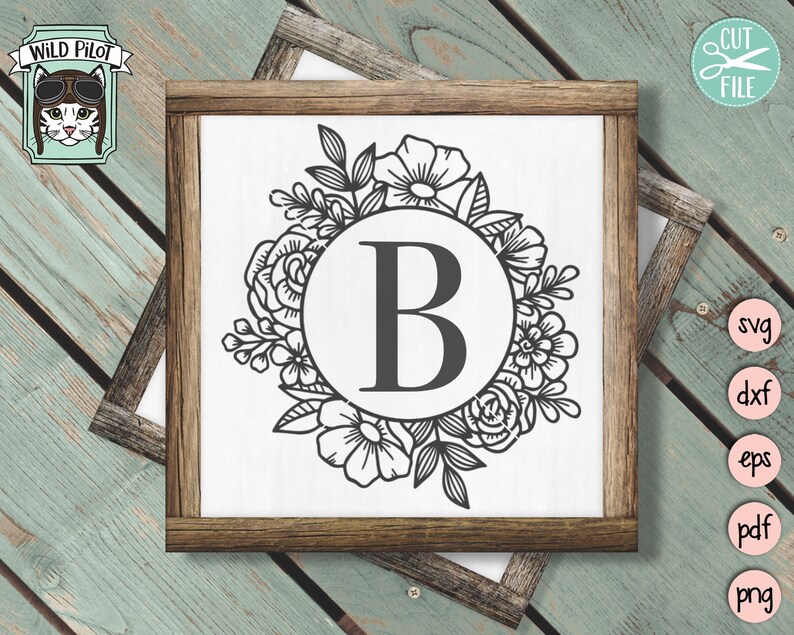 May include: A black and white floral wreath with a circle in the center containing the letter "B".
