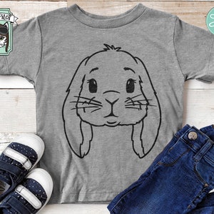 May include: A gray t-shirt with a black outline of a bunny rabbit face. The bunny has large ears and big eyes.