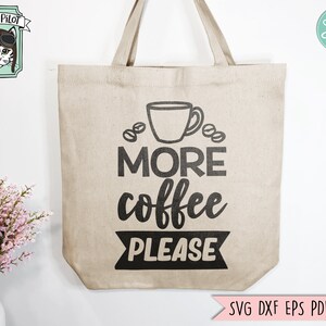 May include: A beige tote bag with black text that reads "More coffee please" and a black silhouette of a coffee cup and coffee beans. The bag has black handles.